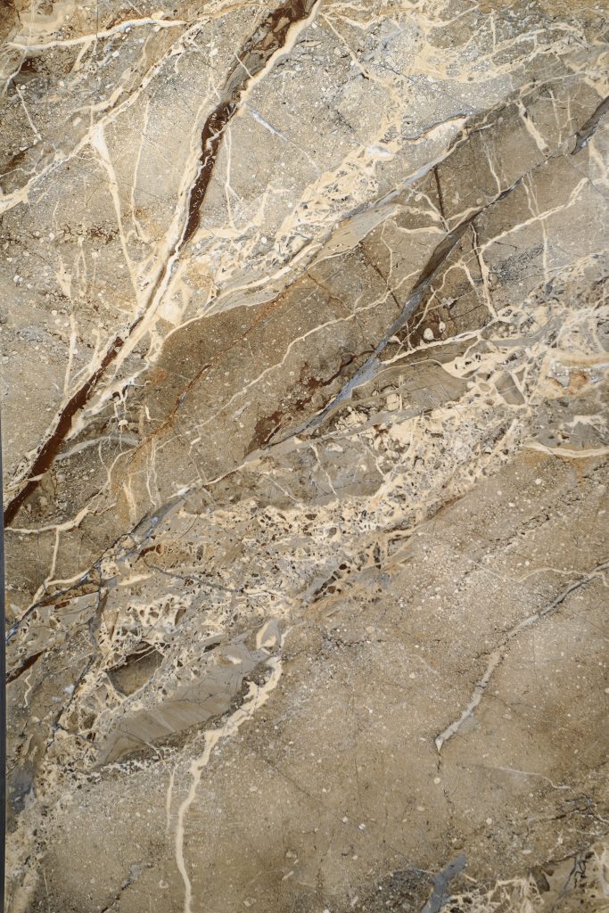 Ceramic porcelain stoneware tile texture or pattern. Natural stone brown color with veining